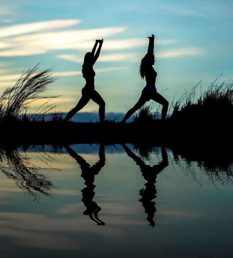 Woman practicing yoga at sunrise